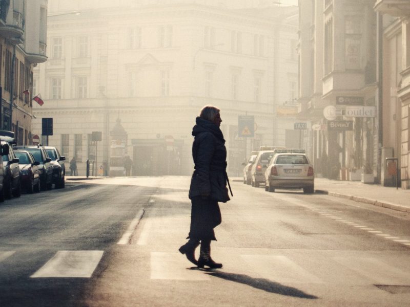 A person in the middle of the streets on Poznan surrounded by old buildings captured in Poland